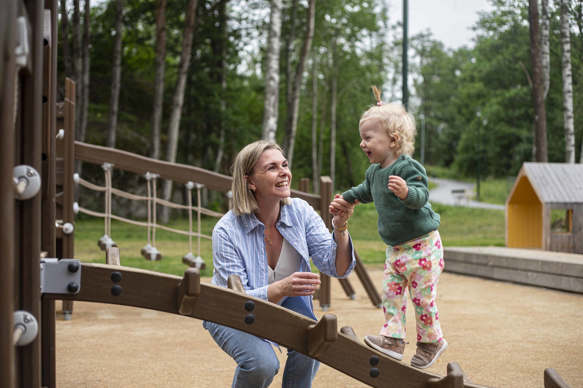 Mamma och barn som leker i en lekpark i Vega